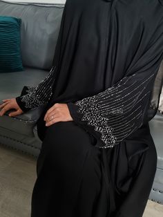 epitome of elegance and luxury: The Classic  Handcrafted Black Butterfly Open Abaya, a masterpiece of timeless beauty and craftsmanship. This exquisite garment is meticulously handcrafted for those special occasions when you demand nothing less than perfection. Open Abaya with buttons, can be worn open or closed. Matching Hijab: Included  Belt: Included  Dry Clean Only  Made in UAE Fabric: 100% Premium Nida(Polyester, lightweight & and soft) with stonework. Pop-up buttons can be worn open or closed, Hijab: A beautiful Matching Hijab included The Model is a UK size 8, Height of 5.5, and wears a size 56. Please check the picture section for the Size Guide Abaya With Buttons, Casual Abaya, Abaya Black, Black Abaya, Open Abaya, Wallpaper Ipad, Night Stands, Black Luxury, Black Butterfly