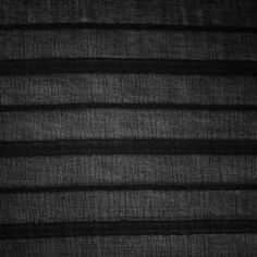 black and white photograph of sheer fabric with horizontal stripes on it, as if in an abstract fashion