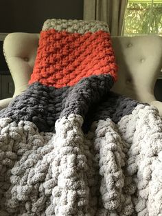 a crocheted blanket sitting on top of a chair