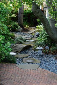 a stone path surrounded by trees and rocks