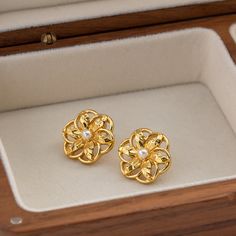 Introducing our stunning Hollow Flower Shaped Stud Earrings, meticulously crafted from durable stainless steel and elegantly adorned with an 18K gold plating. These earrings are a perfect blend of classic charm and modern sophistication, designed to add a touch of glamour to any ensemble. Whether you're attending a wedding, celebrating an anniversary, or simply dressing up for a gala, these earrings are sure to elevate your look. Key Features Material Excellence: Crafted from high-quality stainless steel, ensuring durability and longevity. Luxurious Finish: Enhanced with 18K gold plating for a radiant sheen that captures attention. Waterproof Design: Wear them confidently on any occasion without the fear of damage from water exposure. Hypoallergenic: Free from nickel, lead, and cadmium, ma Tarnish Resistant Gold Flower Earrings For Anniversary, Gold Tarnish-resistant Flower Earrings For Anniversary, Tarnish Resistant Gold Plated Flower Earrings, Elegant Gold Hypoallergenic Flower Earrings, Gold Hypoallergenic Flower Earrings For Anniversary, Classic Gold Flower Earrings For Pierced Ears, Hypoallergenic Gold Flower Earrings For Anniversary, Classic Gold Drop Flower Earrings, Classic Gold Flower Drop Earrings