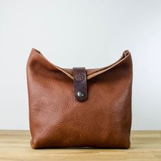 Experience Luxury on-the-go with this Toiletry Bag crafted from Premium Quality Italian leather in Conker Designed with durability and simplicity in mind, this classic yet modern bag is made to stand the test of time.  Finished with a dark brown veg tanned leather clasp with antique brass magnetic fastener.   A perfect accessory that can be used to hold your keys, phone, purse, Passports, make-up, credit cards, coins and much more! And a perfect size to pop in your bag or carry in your hand. App Leather Wash Bag, Modern Bag, Veg Tan Leather, Phone Purse, Makeup Organizer, Travel Toiletries, Makeup Bags Travel, Toiletry Storage, Make Up Bag