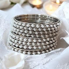 Introducing our exquisite Indian Bridal White Bangle Set, a perfect blend of tradition and elegance.  Elevate your bridal look with this timeless ensemble, designed to capture the essence of Indian craftsmanship and minimalist charm. PLEASS NOTE: For hygiene reasons, jewelry cannot be returned or exchanged White Wedding Bangle For Festive Occasions, White Wedding Bangle For Festive Season, Festive White Wedding Bangle, Traditional Silver Bracelets For Wedding, Elegant Bangle With Intricate Design For Marriage, Delicate Stackable Wedding Bracelets, Elegant Festive Stackable Jewelry, White Festive Bangle For Marriage, Adjustable Stackable Bangle For Wedding