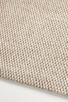 a close up view of a beige carpet