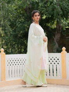 Set of 3 consists of kurta, sharara and dupatta Noor, bringing the magic of festivities straight to your closet in shades of pastels. Kurta: A pastel medley baby pink chanderi kurta with heavy gota jhaal detailing on the neckline, sleeves & hemline. Dupatta: A light pista green chanderi dupatta adorned with gota flowers. Pants: Ghera sharara in soft mul mul adorned with minimal gota detailing. Occassion: Day Wear, Evening Wear, Festive Wear Fabric: Chanderi Wash Care Instructions: Dry Clean Chanderi Dupatta, Pista Green, Kurta Sharara, Sharara Set, Festive Wear, Festival Wear, Evening Wear, Baby Pink, Pink And Green