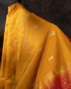 "Experience the vibrant beauty of our Handwoven Narali Kath yellow pure silk yeola paithani. Handcrafted with traditional weaving techniques, each piece is a unique work of art. Add a touch of elegance and tradition to your wardrobe (without breaking the bank!). No two are alike. Limited edition!" Gold Dupatta For Puja With Traditional Drape, Silk Traditional Wear For Puja And Festivals, Yellow Saree With Motifs For Transitional Season, Gold Silk Traditional Wear For Festivals, Festive Yellow Traditional Wear With Motifs, Yellow Raw Silk Traditional Wear With Motifs, Gold Dupatta For Puja In Traditional Drape, Yellow Unstitched Saree For Traditional Ceremonies, Yellow Semi-stitched Traditional Wear With Patterns