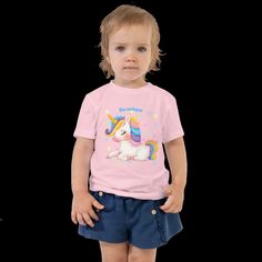 Cute children's shirt made of cotton. This sweet baby shirt features an enchanting unicorn print. Comfortable and also a gift for any little girl or boy. Let your kids run around in this short-sleeved 100% cotton jersey T-shirt with a unique print. The T-shirt is soft, durable and a staple in your child's wardrobe. * 100% combed ring-spun cotton * Fabric weight: 142 g/m² * Pre-shrunk material * Side seam * Relaxed fit for added comfort * Raw product sourced from Honduras or the USA Fun Unicorn Print T-shirt For Summer, Cute Unicorn Print Birthday T-shirt, Casual Unicorn Print T-shirt For Spring, Playful Cotton T-shirt With Unicorn Print, Cute Summer Cotton T-shirt, Cotton T-shirt With Unicorn Print For Spring, Playful Cotton T-shirt With Cute Design, Spring Cotton T-shirt With Unicorn Print, Playful Short Sleeve T-shirt As Gift