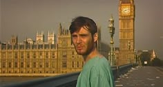 a man standing in front of the big ben clock tower