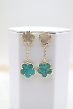 The Gold Plated Mother of Pearl and Turquoise Five Leaf Flower Petal Pendant Earrings feature a stunning design with five petals, each inlaid with iridescent mother of pearl and turquoise, radiating from a central gold-plated core. These exquisite earrings add a touch of sophistication and natural beauty to any ensemble, perfect for enhancing special occasion outfits. Length: 51.9 mm Width: 14.9 mm; 18.5 mm Closure: Butterfly Earring Backs Material: Brass with 18K Gold Plating with Rhodium Coati Turquoise Jewelry With Flower Charm, Elegant Turquoise Jewelry With Flower Charm, Turquoise Dangle Jewelry With Flower Charm, Elegant Turquoise Earrings With Flower Charm, Elegant Turquoise Drop Flower Earrings, Elegant Turquoise Flower Drop Earrings, Turquoise Flower Charm Jewelry, Turquoise Earrings With Flower Charm, Turquoise Dangle Earrings With Flower Charm