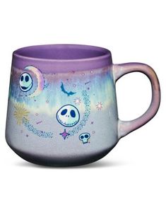 a purple coffee mug with skulls and stars on it