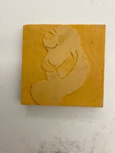 a yellow square with a drawing of a bear on it