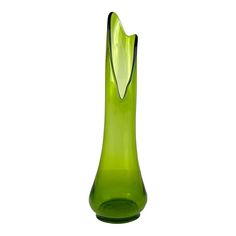 a green glass vase sitting on top of a table