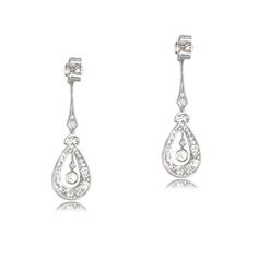 This lovely pair of earrings is Edwardian inspired, featuring intricate details in handcrafted platinum. Old mien cut diamonds are set along the drop of the earrings, surrounding the center diamond. The total approximate weight of these earrings is 2.00 carats. ✦ EARRING SPECIFICATIONS: Ring Material: Platinum Ring Era: Edwardian Era Stones: Diamond ✦ WHAT COMES IN YOUR SHIPMENT: - Your Engagement Ring - Quality Ring Box - Jewelry Cleaner - UGL Certificate ✦ WHY SHOP WITH US: - We've been in bus Formal Pear-shaped Chandelier Earrings, Art Deco Silver Diamond Earrings In Platinum, Silver Art Deco Platinum Diamond Earrings, Art Deco Diamond Drop Earrings For Formal Occasions, White Gold Platinum Drop Bridal Earrings, Platinum White Gold Drop Bridal Earrings, Elegant Oval Earrings With Intricate Design, Classic White Gold Sterling Silver Chandelier Earrings, Classic Sterling Silver Chandelier Earrings In White Gold