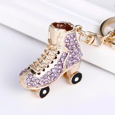 a pair of roller skates with purple and pink crystals on them, sitting on a white surface