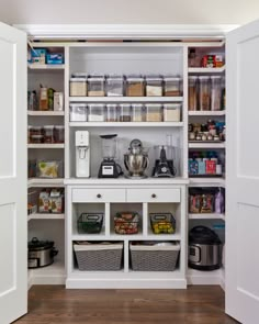 an organized pantry with white shelves and baskets