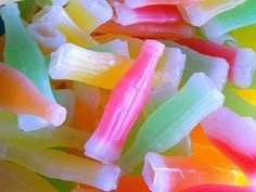 a pile of gummy bears with the caption who remembers eating this candy?