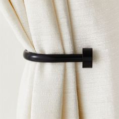 a curtain with a black handle attached to it