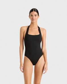 The Candice one piece in black is an elegant, feminine halterneck swimsuit that will never go out of style. The suit also works perfectly as a bodysuit worn under trousers or a skirt. A comfortable, wide, elasticated strap runs from under the shoulders and behind the neck. A scoop back reveals the shoulders. Self-lined in our ultra-soft Embodee™ fabric with high shaping power, Candice will become your go-to suit every summer. Luxury fabric sustainably made in Italy. Resort Wear Dresses, Summer Luxury, Halter Neck Swimsuit, Luxury Fabric, Elegant Feminine, Australian Fashion, Shop Swimwear, Luxury Fabrics, A Skirt