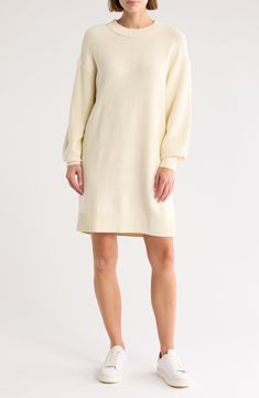 Chunky rib-knit hems and roomy drop-shoulder sleeves emphasize the oversized, cozy shape of a sweater dress babydoll dress ready for any season. Crewneck Long sleeves 60% cotton, 40% acrylic Hand wash, dry flat Imported Casual Sweater Dress With Ribbed Cuffs For Spring, Beige Crew Neck Sweater Dress For Spring, Cream Knitted Sweater Dress For Fall, White Crew Neck Sweater Dress For Fall, Cozy Long Sleeve Cream Dress, Cozy Cream Long Sleeve Dress, Beige Long Sleeve Sweater Dress For Loungewear, Casual Winter White Dresses For Winter, Casual Winter White Dress