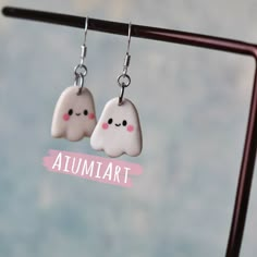 two white clouds with pink eyes are hanging from silver earwires that say,'autumn '