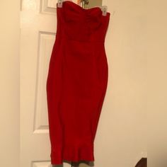 a red dress hanging on a door