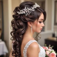 a woman in a wedding dress holding a bouquet and wearing a bridal tiara