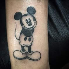 a cartoon mickey mouse tattoo on the right arm and leg, it is black and white