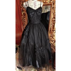 This gorgeous formal gown is from the 50s by Emma Domb.  Rare solid black.  The underdress is made up of a black shiny acetate. There are two layers of tulle.  The under layer is a coarse tulle to give it its shape.  The outer layer is a finer tulle.  On the bodice and on the skirt are large lace bow appliques. The bodice is boned for structure. Side metal zipper.  There is one repair on the satin underdress near the hem where it looks like the original owners high heel might have gone through. You can't see this  when wearing the dress.  The hem of the tulle in some places has been trimmed (shown) This also does not show because of the fullness and the double layer of tulle.  This is a gorgeous gown and perfect for any formal event or Prom.  It was photographed with an extra petitcoat (no Black Tulle Ball Gown For Evening, Evening Ball Gown With Tulle Skirt, Black Organza Gown With Sheer Details, Gothic Ball Gown For Evening, Black Organza Evening Gown, Vintage Black Gown For Wedding, Vintage Black Wedding Gown, Vintage Tulle Skirt Dress For Party, Vintage Tulle Dress For Party