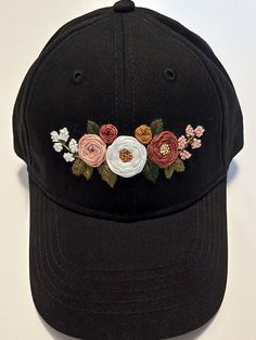 a black hat with flowers embroidered on it