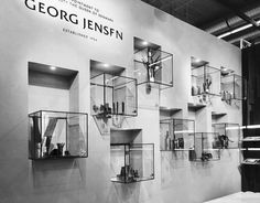 a wall with several glass shelves on it and the words georg jelsfn above them