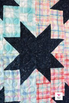 a close up view of a quilted star