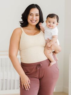 A buttery-soft bamboo cami for around-the-clock comfort. Crafted from stretchy, breathable fabric, this nursing & pumping camisole features a flattering scooped neckline and a built-in shelf bra for extra support. The patented double-layer system gives you the feeding flexibility you love; for hands-free pumping, simply unclip the outer layer, and slide your flanges through the openings in the inner layer, and for nursing, unclip both layers. Perfect for pregnancy or postpartum, pumping or nursi Beige Tank Top With Built-in Bra For Loungewear, Supportive Tops For Everyday Summer Wear, Supportive Summer Tops For Everyday, Supportive Summer Tops For Everyday Wear, Supportive Everyday Summer Tops, Fitted Beige Camisole For Everyday, Everyday Fitted Beige Camisole, Beige Fitted Camisole For Everyday, Casual Spaghetti Strap Tank Top For Relaxation