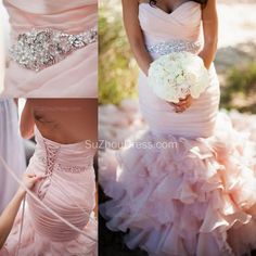 the bride is wearing a pink wedding dress with ruffled layers and jeweled belt