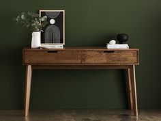 a wooden table with two vases on it and a framed photograph next to it