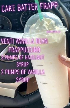 a person holding up a cup with whipped cream in it and the words, cake batter frapp