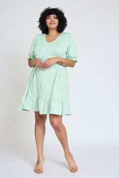 You will absolutely love this floral mini dress's delicate, feminine look that is perfect to add to your closet for Spring! This lovely dress is adorn with a v-neckline and a adorable ruffle trim at the hem and sleeves. 95% Polyester 5% Spandex Made in the USA V-neck, short puff sleeve, ruffle trimmed sleeves and hem, empire waistline with elastic, above the knee length SIZE: (Fits true to size) S(2-4), M(6-8), L(10-12), XL(14-16), 1X(18), 2X(20), 3X(22) S: Bust 34.5" Waist 30" Length 36"M: Bust Spring Mini V-neck Dress With Ruffle Hem, Feminine Knee-length Ditsy Floral Mini Dress, Feminine Knee-length Mini Dress With Ditsy Floral Print, Knee-length Flowy Mini Dress With Ditsy Floral Print, Feminine V-neck Dress With Ditsy Floral Print, Casual V-neck Floral Dress With Ruffle Hem, Flowy Ditsy Floral Print V-neck Dress, Feminine Green V-neck Mini Dress, Feminine Flowy V-neck Floral Dress