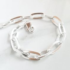 Details:  - one (1) solid sterling silver chain-link bracelet - fits wrists 7.5" and under  - each link is 1/4" x 1/2" Add a charm to the bracelet with this listing: https://www.etsy.com/listing/562251733/add-on-charm-for-necklaces-or-expandable?ref=shop_home_active_1&pro=1 » DON'T FORGET TO GRAB A SUNSHINE POLISHING CLOTH: https://www.etsy.com/listing/469627127/sunshine-cleaning-cloth-for-jewelry?ref=shop_home_active_1 » CHECK OUT MY ENTIRE SHOP https://www.etsy.com/shop/TatumBradleyCo?ref=si_s Chunky Silver Jewellery, Chunky Silver Bracelet, Silver Gold Jewelry, Silver Bracelets For Women, Chic Bracelet, Toggle Bracelet, Engraved Bracelet, Birthday Gifts For Women, Silver Jewellery