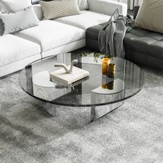 a glass coffee table sitting on top of a carpeted floor next to a couch