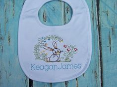 "This adorable baby boy or girl bib &/or burp cloth is the perfect baby gift for that beautiful sweet baby! Can be for a boy or girl. Girl bib and burps cloths have ruffles. The personalized bib &/or burp cloth will be a hit as a baby gift and at your next baby shower! Our premium baby bibs and burp cloths feature an interlock knit top layer, and a chenille terry cloth back layer. . Bibs & burp cloths are available in white, blue and gray for boys. Pink or white with ruffles for girl Cute Handmade White Bib, Cute White Handmade Bib, Cute White Bib For First Birthday, Personalized Bib For First Birthday, Personalized White Bib For Birthday, Personalized White Birthday Bib, Personalized Baby Bibs, Girls Bib, Burp Cloth Set