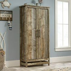 a wooden cabinet sitting in the corner of a room