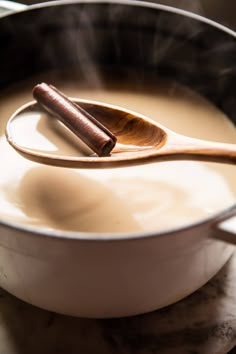 a wooden spoon in a pot filled with liquid