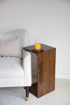 a small wooden table with a glass on it