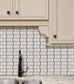 a kitchen counter with two sinks and a faucet