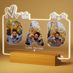 a wooden stand with three photos on it and the words i love you dad written in white