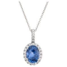 Crisp and bright sapphire and diamond in a classic pendant necklace. A stunning 2.50 Carat oval sapphire is at the center of this 14k white gold setting, accented by 23 round brilliant cut shimmering diamonds, creating a luxurious and eye-catching design. 18 inch 14k white gold chain. The GIA has certified it as natural, no heat. Designed and crafted in the Peter Suchy Workshop. 1 oval blue sapphire, SI approx. 2.50cts GIA Certificate # 2235070041 23 round brilliant cut diamonds, G VS SI approx. Brilliant Cut Sapphire Oval Pendant, Sapphire Jewelry With Brilliant Cut Oval Pendant, Formal Blue Oval Diamond Necklace, Oval Sapphire Diamond Necklace, Classic Sapphire Diamond Necklace For Formal Occasions, Classic Formal Sapphire Diamond Necklace, Classic Sapphire Necklace For Formal Occasions, Classic Sapphire Diamond Necklace With Brilliant Cut, Oval Sapphire Necklace With Brilliant Cut