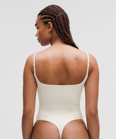 Backless Bodysuit With Built-in Bra And Minimal Stretch, Second-skin Bodysuit With Spaghetti Straps And Built-in Bra, Elegant Seamless Backless Bodysuit, Elegant Summer Bodysuit With Minimal Stretch, Elegant Beige Second-skin Bodysuit, Elegant Solid Color Sculpting Bodysuit, Elegant Sculpting Solid Bodysuit, Summer Shaping Bodysuit In Beige, Elegant Bodysuit With Minimal Stretch And Lined Body