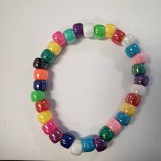 a multicolored beaded bracelet on a white surface