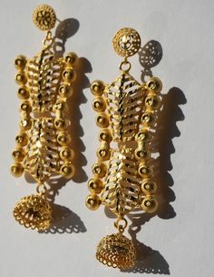 These unique treasures, crafted from brass and plated in radiant 24K gold, showcase the jewelry style found in Senegal. Embrace the beauty of heritage with this piece, connecting you to the soulful charm of Senegal's vibrant markets. 24K Plating over brass 5.25in Length Metal Temple Jewelry Chandelier Earrings, Temple Jewelry Style Metal Chandelier Earrings, Brass Chandbali Danglers, Brass Chandbali Danglers With Matching Earrings, Metal Chandelier Earrings With Latkans In Temple Jewelry Style, Temple Jewelry Style Metal Drop Earrings, Gold Plated Clip-on Earrings, Festive Metal Temple Jewelry Earrings, Elegant Brass Danglers For Festivals