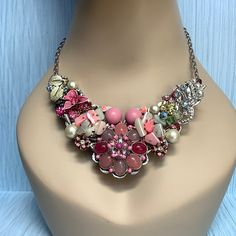 "A new silver toned bib necklace base adorned with pink silver and crystal vintage brooches and earrings.  17\" long.  Let me know if you want an extender added." Pink Rhinestone Costume Jewelry, Pink Jeweled Metal Jewelry, Pink Rhinestone Jeweled Costume Necklace, Pink Rhinestone Costume Jewelry Necklace For Gift, Pink Jeweled Rhinestone Costume Necklace, Pink Metal Jewelry With Vintage Charm, Pink Vintage Charm Metal Jewelry, Pink Rhinestone Costume Jewelry Necklace, Pink Metal Necklace With Jewels