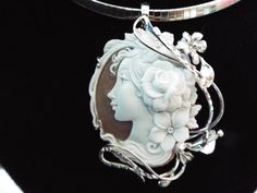 "This is a beautiful modern master hand carved sardonyx cameo by the artist, Carla. This is a very complex and intriguing piece and the design makes it an absolutely amazing piece of work. All the detail is exceptionally done to perfection! The right cameo is cameo is 48 mm mm (1.89\") and it is set into Italian silver with a 6 mm enhancer bail and a pin attachment. It comes packed in a black velvet box and certificate of authenticity for gift giving. Welcome to CASCO Cameos, LLC. CASCO Cameos i Exquisite Cameo Jewelry For Formal Occasions, Elegant Oval Pendant Collectible Jewelry, Unique White Collectible Jewelry, Exquisite Cameo Jewelry For Gift, Elegant Carved Necklaces For Formal Occasions, Elegant Carved Necklace For Formal Occasions, Elegant White Collectible Jewelry, Exquisite Silver Collectible Jewelry, White Gold Cameo Jewelry Gift